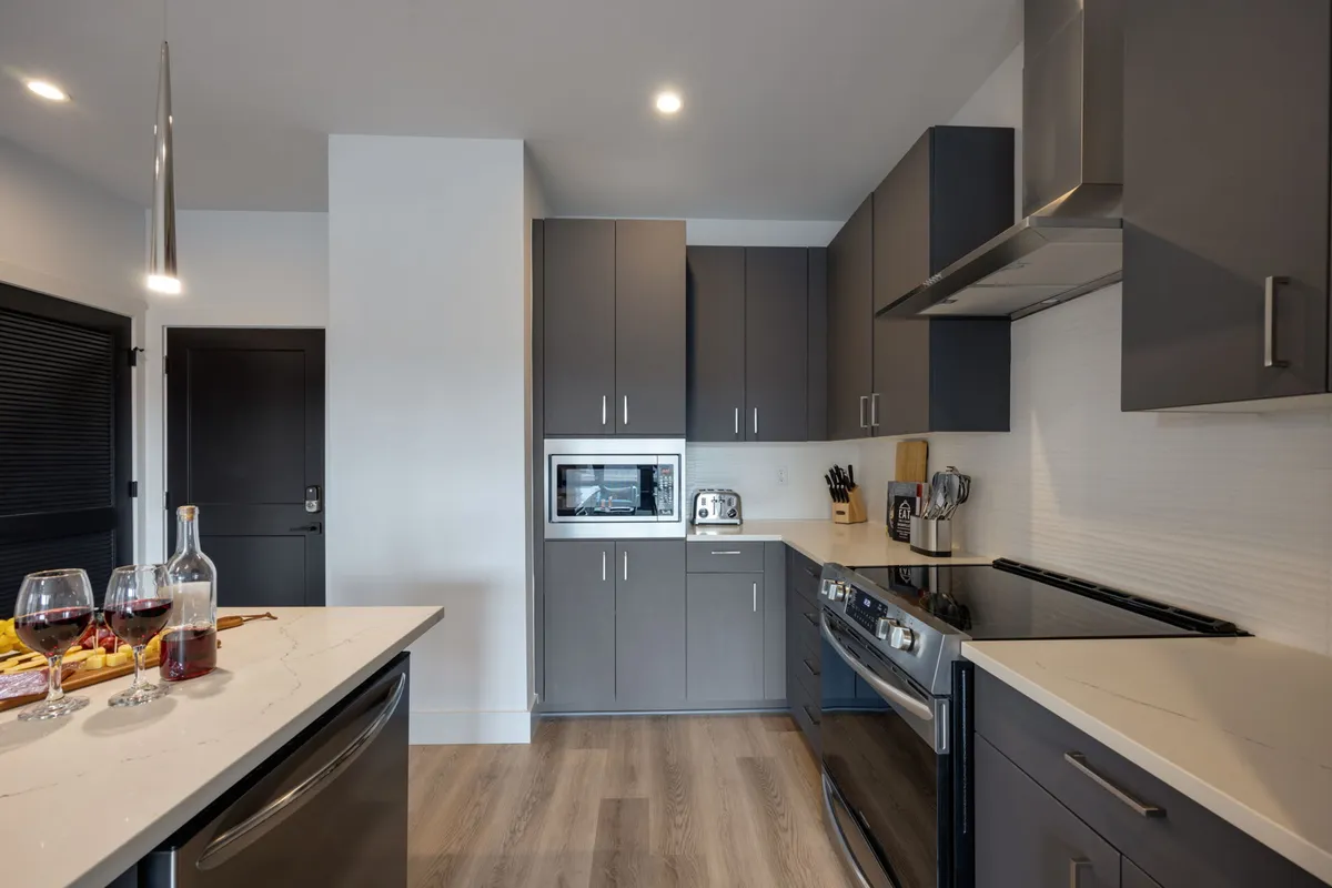 A modern bathroom features a double vanity with ample counter space, sleek cabinetry, and a large mirror. Stainless steel fixtures and soft lighting create a spa-like setting ideal for morning and evening routines.